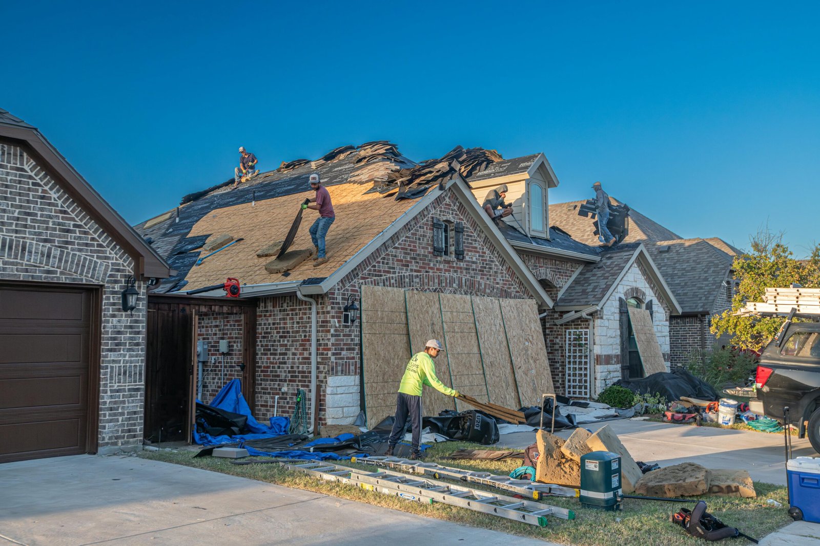 a group of men working on a roof of a house
